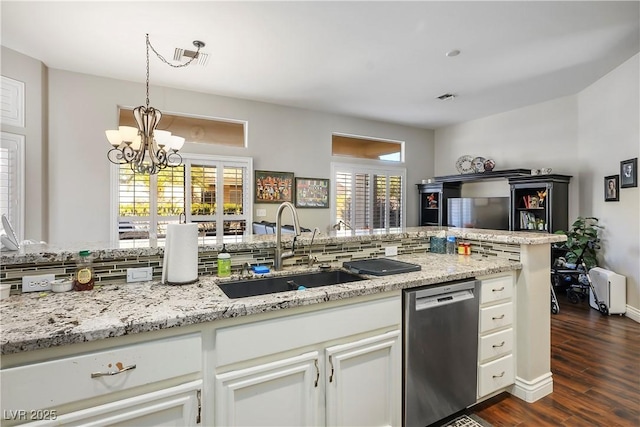 kitchen featuring stainless steel dishwasher, a notable chandelier, sink, and white cabinetry