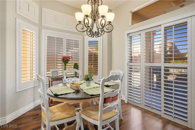 dining area featuring dark hardwood / wood-style floors and a notable chandelier