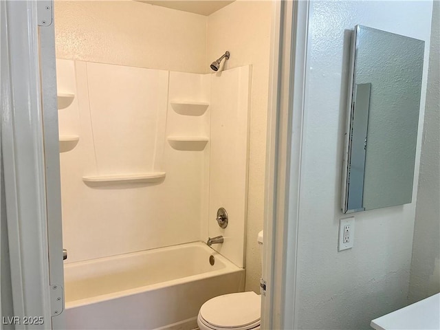 bathroom with toilet and washtub / shower combination