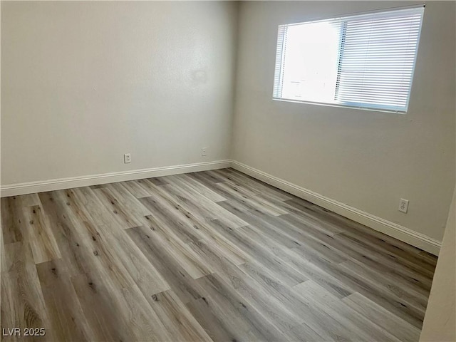 spare room featuring light hardwood / wood-style flooring