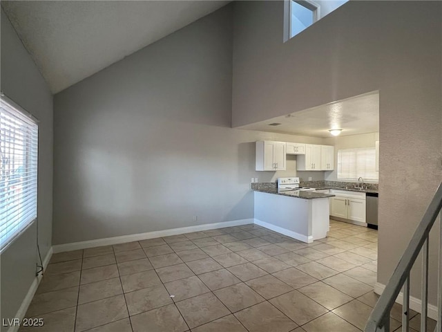 kitchen with kitchen peninsula, light tile patterned floors, high vaulted ceiling, white range with electric stovetop, and white cabinetry