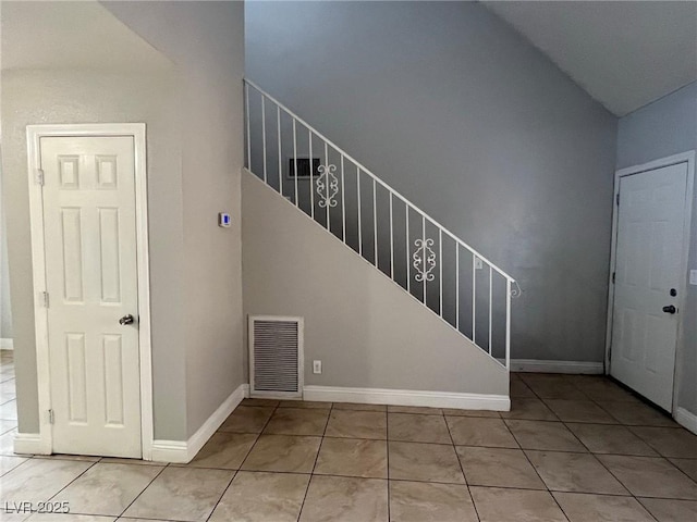 tiled foyer with lofted ceiling