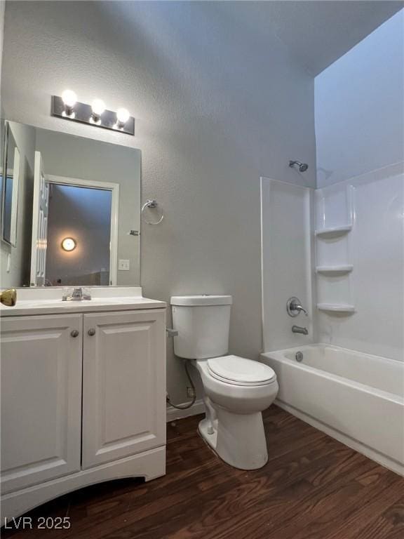 full bathroom with toilet, hardwood / wood-style flooring, shower / bath combination, and vanity