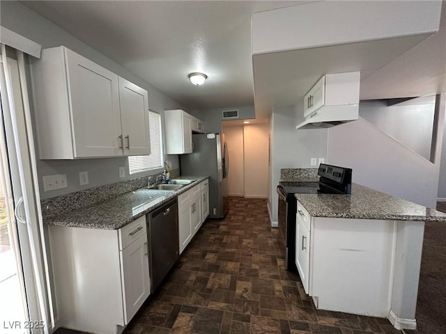 kitchen with sink, stainless steel appliances, white cabinetry, and dark stone counters