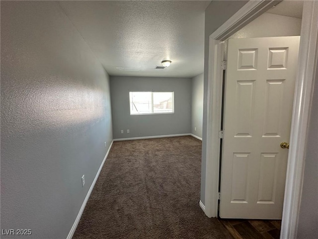 carpeted spare room featuring a textured ceiling