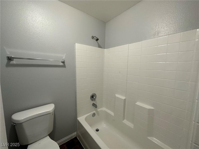 bathroom with toilet and  shower combination