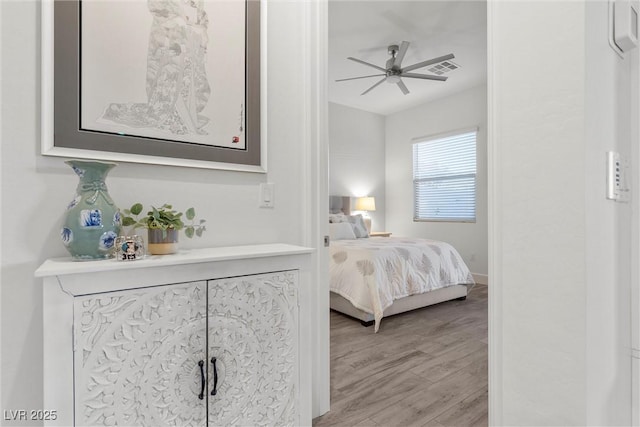 bedroom with ceiling fan and light wood-type flooring