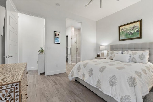 bedroom with ceiling fan, connected bathroom, and light hardwood / wood-style floors