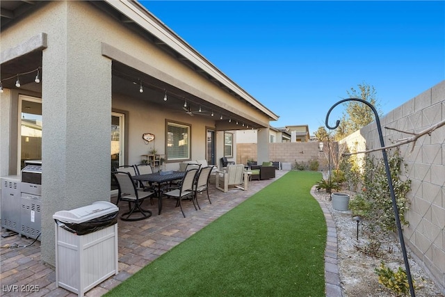 view of yard featuring ceiling fan and a patio