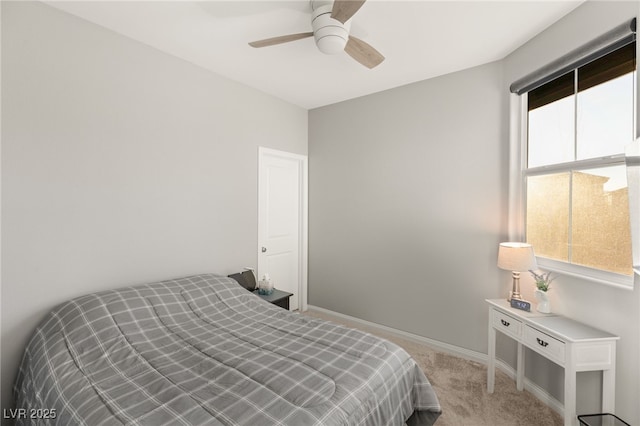 carpeted bedroom with multiple windows and ceiling fan