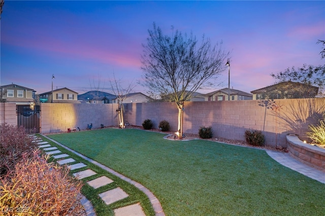 view of yard at dusk