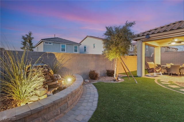 yard at dusk with a patio area