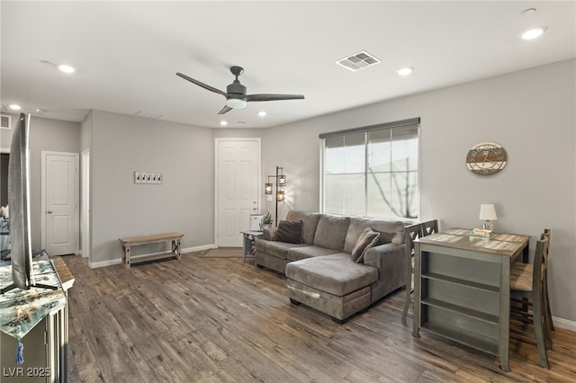 living room with ceiling fan and dark hardwood / wood-style floors