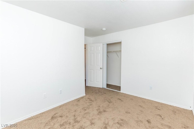 unfurnished bedroom featuring a closet and light carpet