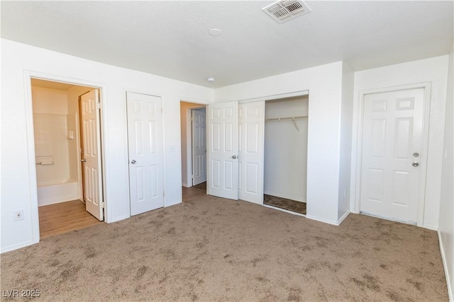 unfurnished bedroom with carpet flooring and connected bathroom