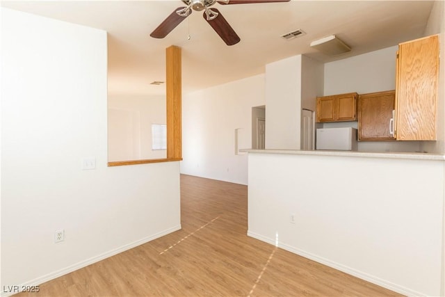 interior space featuring ceiling fan and light hardwood / wood-style flooring