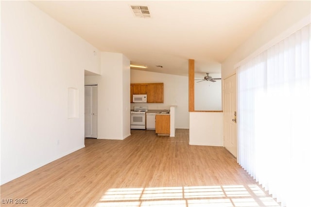 unfurnished living room featuring lofted ceiling, ceiling fan, and light hardwood / wood-style flooring