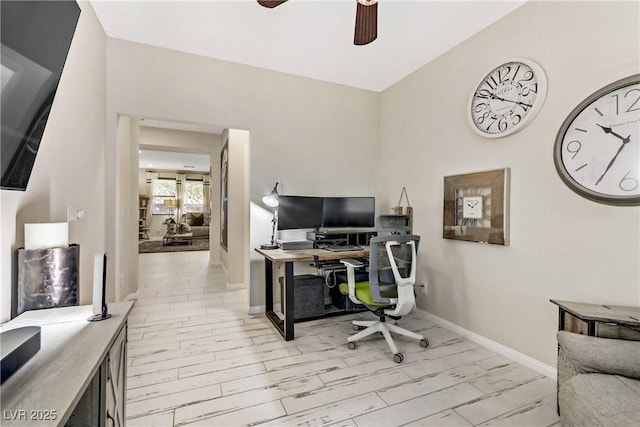 home office with light wood-type flooring and ceiling fan