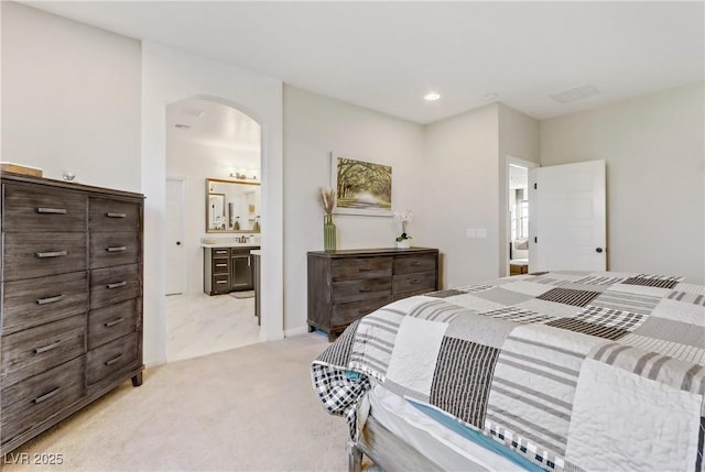 carpeted bedroom with ensuite bath