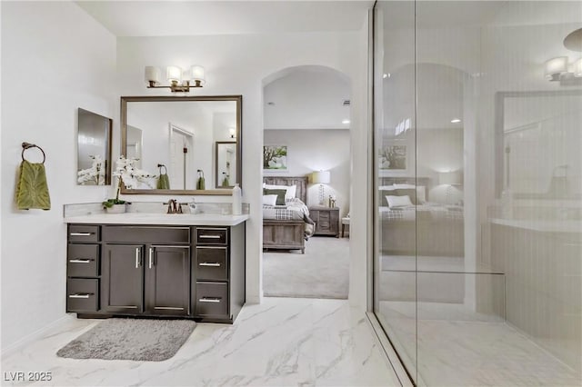 bathroom with walk in shower and vanity