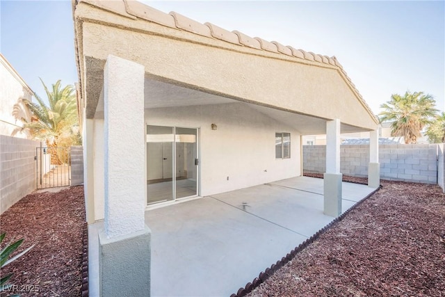 back of property with a patio