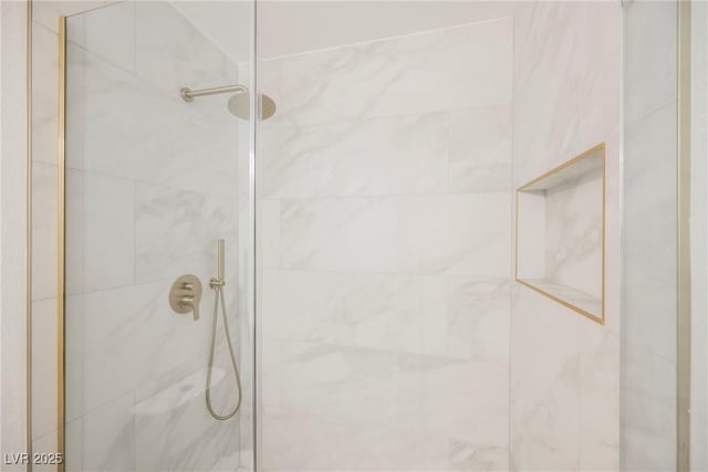 bathroom with a tile shower