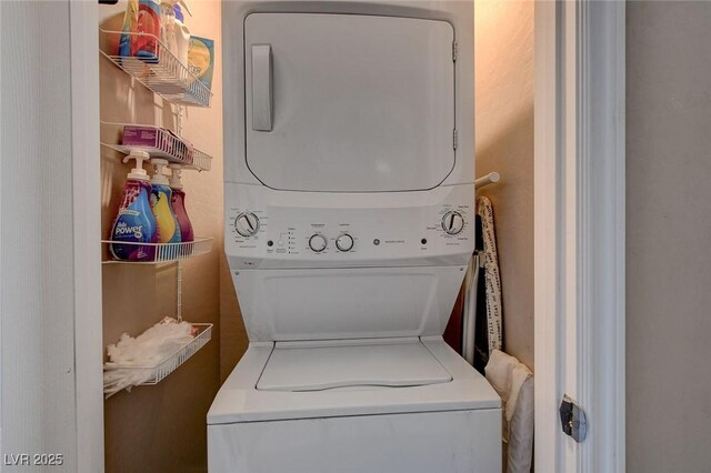 laundry area with stacked washer and clothes dryer