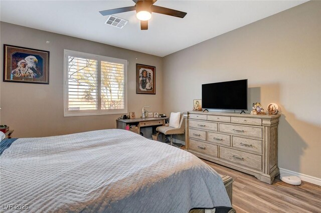 bedroom with ceiling fan and light hardwood / wood-style floors