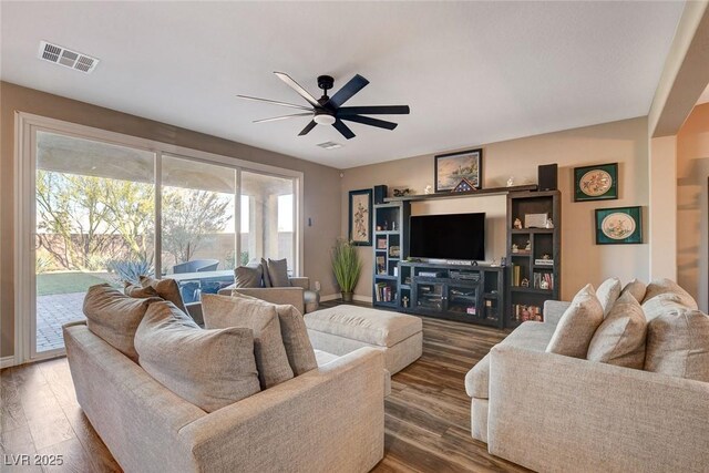 living room featuring a wealth of natural light, ceiling fan, and wood-type flooring