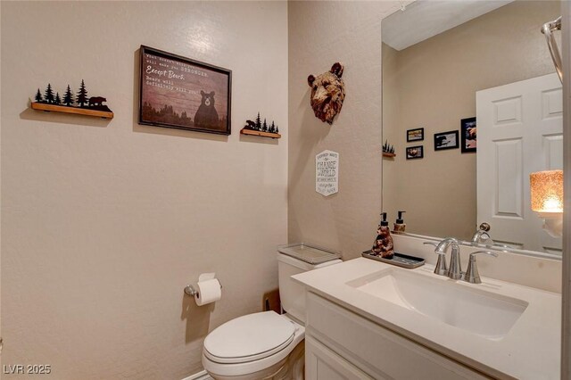 bathroom featuring toilet and vanity