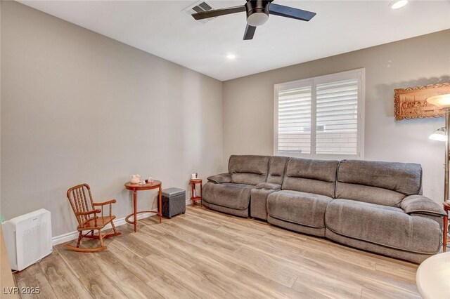 living room featuring ceiling fan and light hardwood / wood-style floors