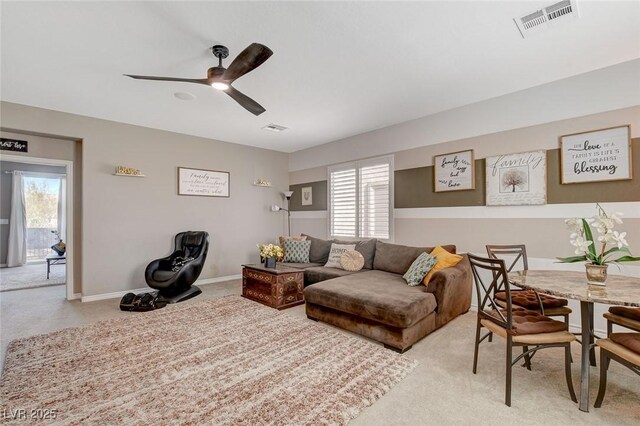 living room featuring ceiling fan and light colored carpet