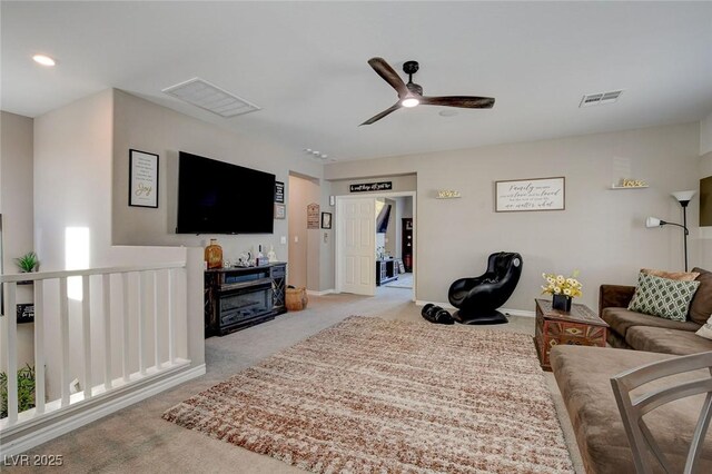 living room with ceiling fan and light colored carpet