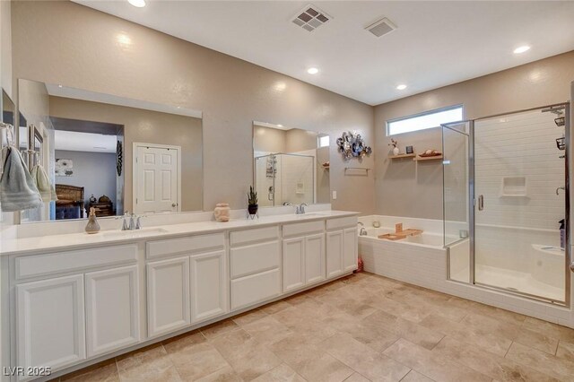 bathroom featuring separate shower and tub and vanity