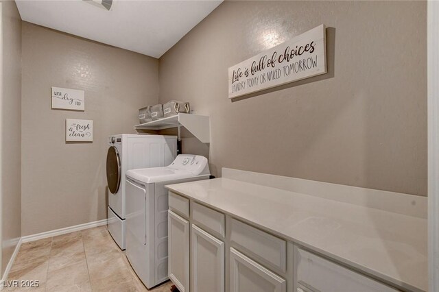 laundry room with separate washer and dryer, cabinets, and light tile patterned flooring