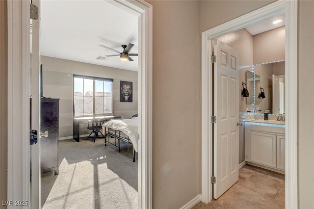 corridor with light colored carpet and sink