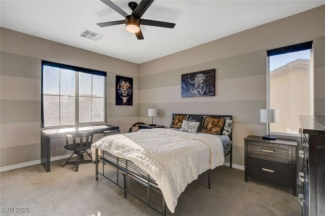 bedroom with multiple windows, light carpet, and ceiling fan