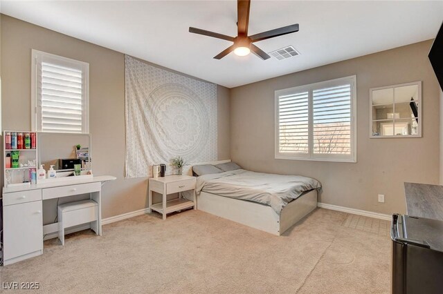 bedroom featuring ceiling fan and light carpet