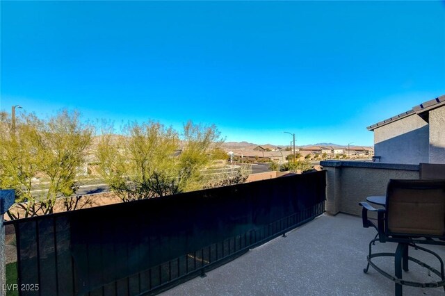 view of patio featuring a balcony and a mountain view