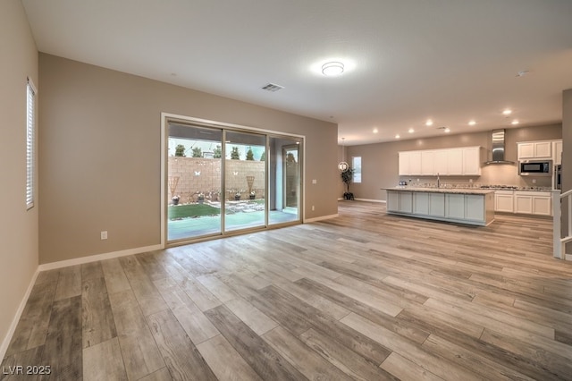 unfurnished living room with light hardwood / wood-style flooring