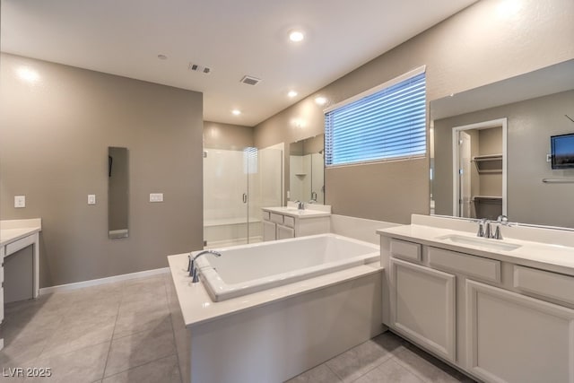 bathroom featuring tile patterned floors, independent shower and bath, and vanity