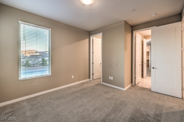 unfurnished bedroom featuring light carpet