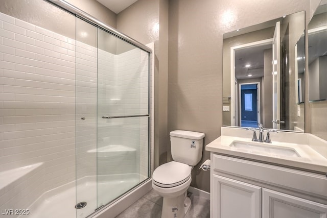 bathroom featuring toilet, an enclosed shower, tile patterned floors, and vanity