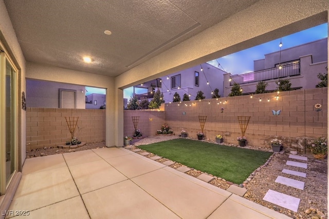 patio terrace at dusk with a lawn