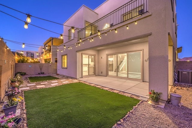 back of house with a yard, a balcony, central AC unit, and a patio