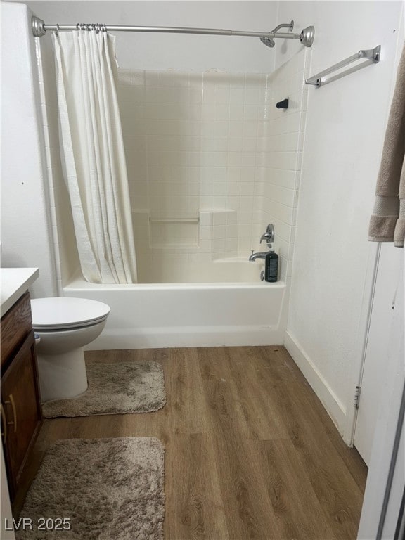 full bathroom featuring toilet, wood-type flooring, vanity, and shower / tub combo