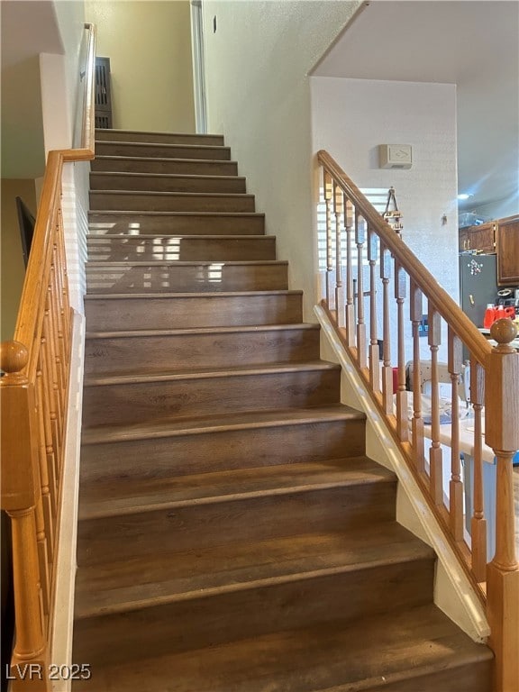 stairs with hardwood / wood-style floors