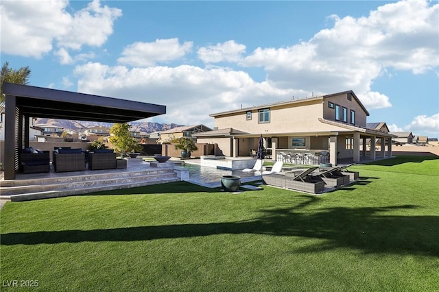 back of property featuring exterior bar, a patio area, a lawn, and an outdoor hangout area