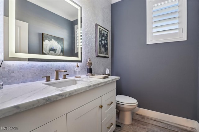 bathroom featuring toilet and vanity