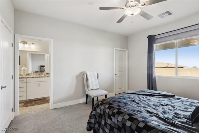 bedroom featuring ceiling fan, ensuite bathroom, and light carpet